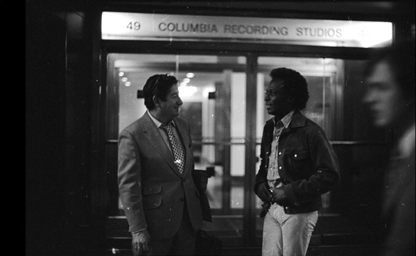 Teo and Miles standing in front of the Columbia Records recording at night