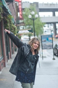 Gretta Harley standing on a street corner seemingly hailing a taxi.