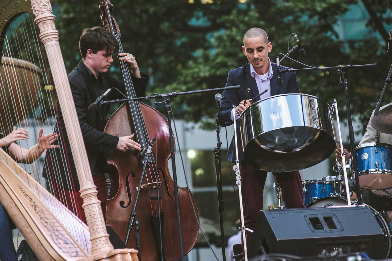 Andy Akiho performing on steel pans along with harp and double bass during the June 10, 2016 IN/TERSECT concert in Bryant Park
