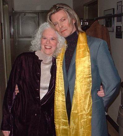 Martha Mooke and David Bowie wearing a long yellow scarf.