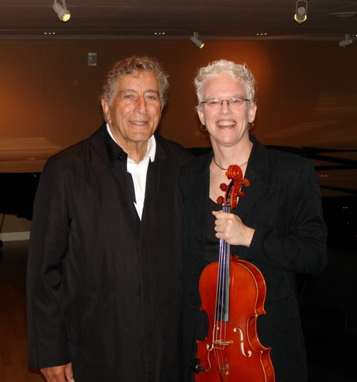 Tony Bennett standing next to Martha Mooke who is holding a viola.