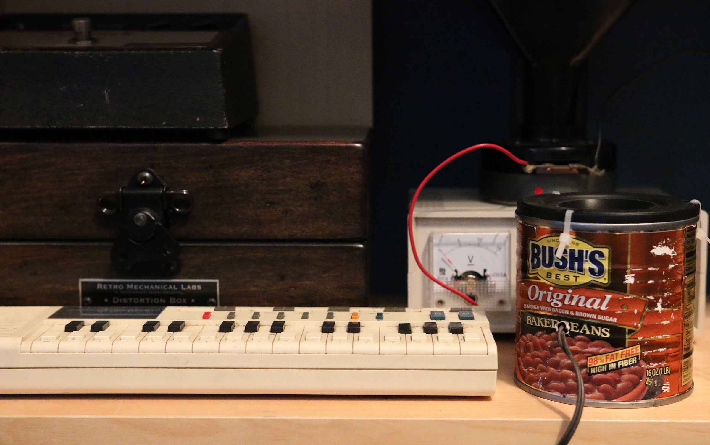 One of Schumacher's synthesizers connected to a speaker made from a Bush Beans can.