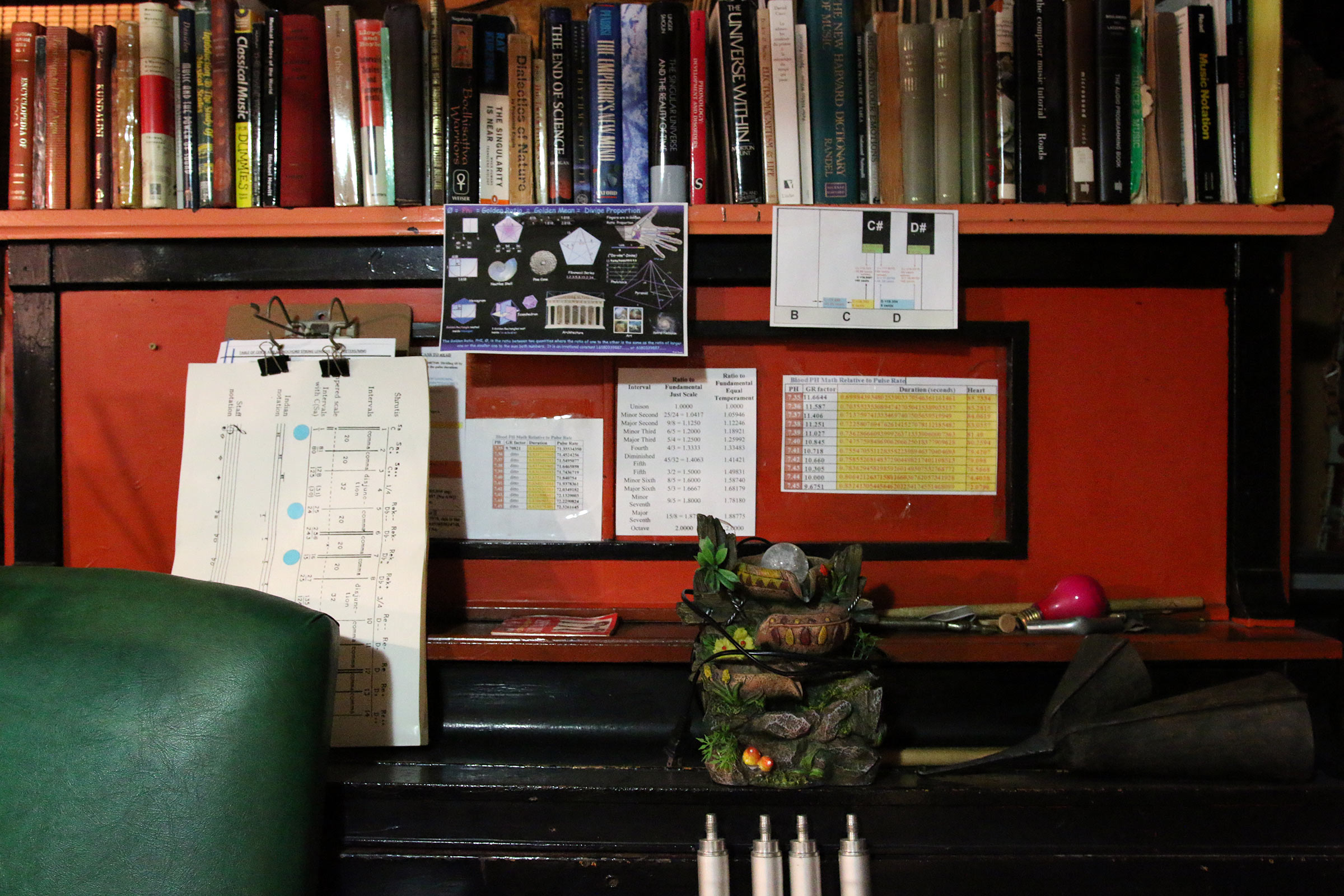 Books, tools, and musical diagrams share space in Milford Graves's studio