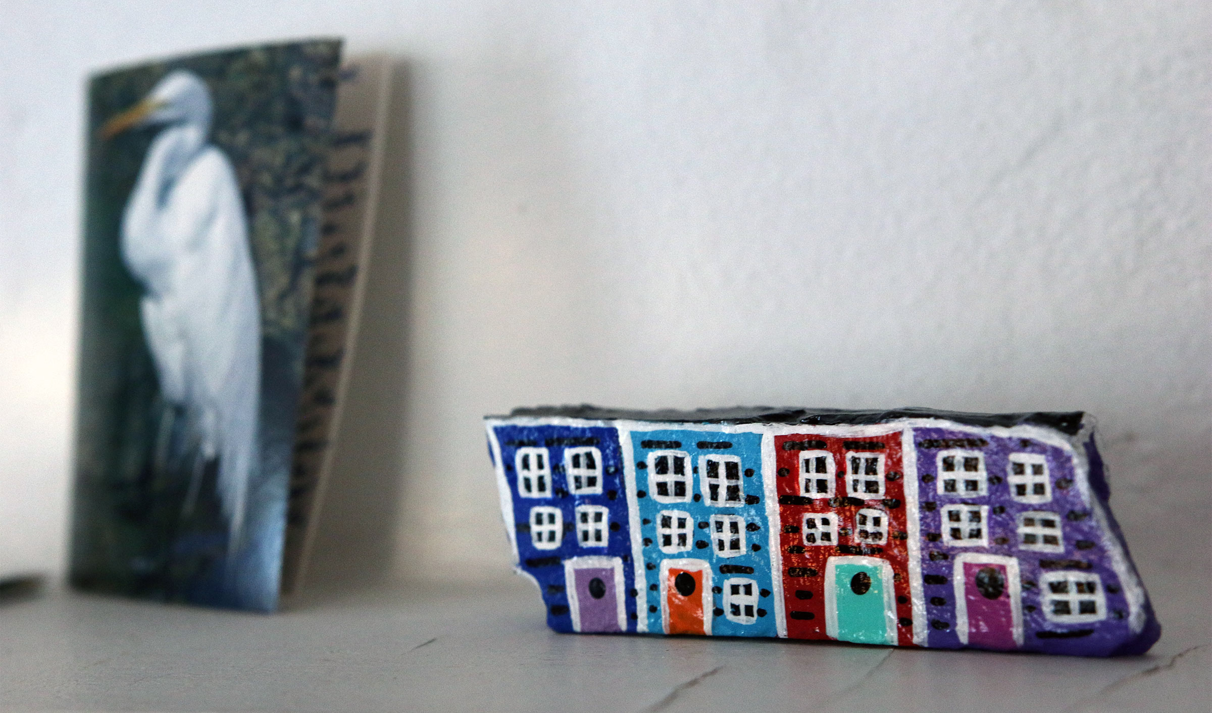 A set of miniature houses is on one of Barbara White's shelves.