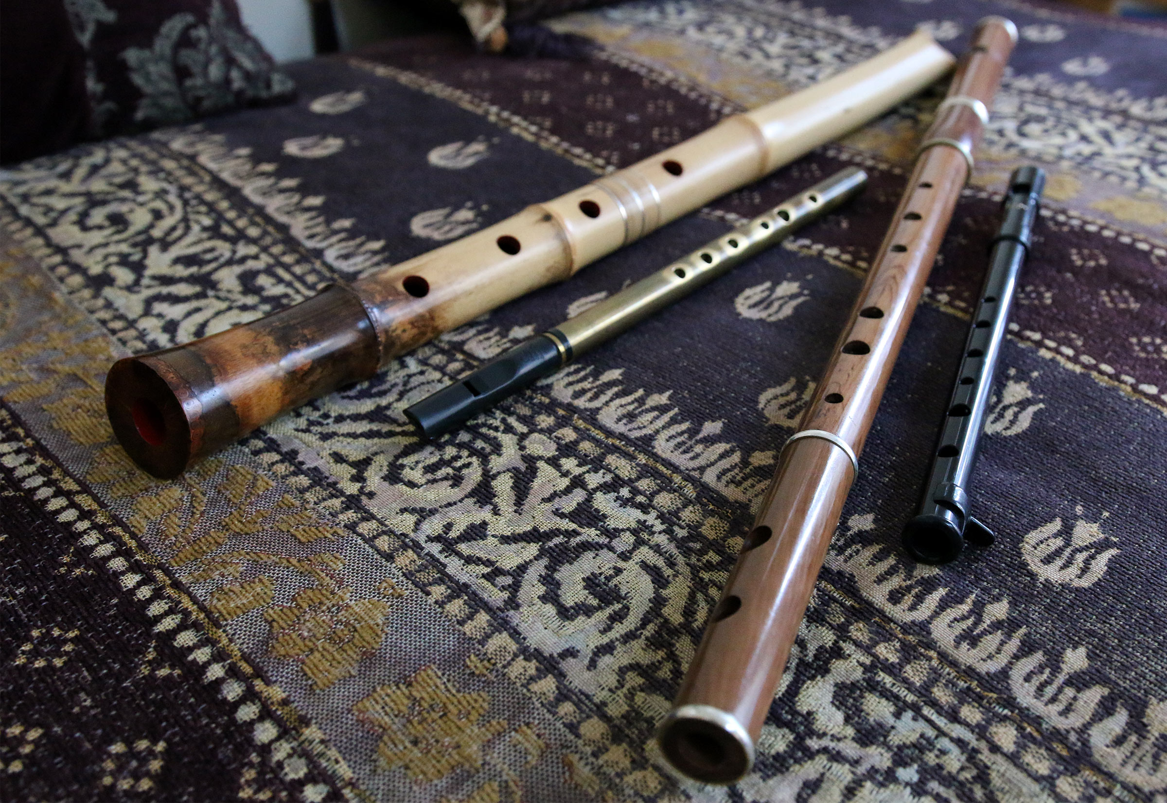 Several of Barbara White's flute including a pennywhistle and a shakuhachi.