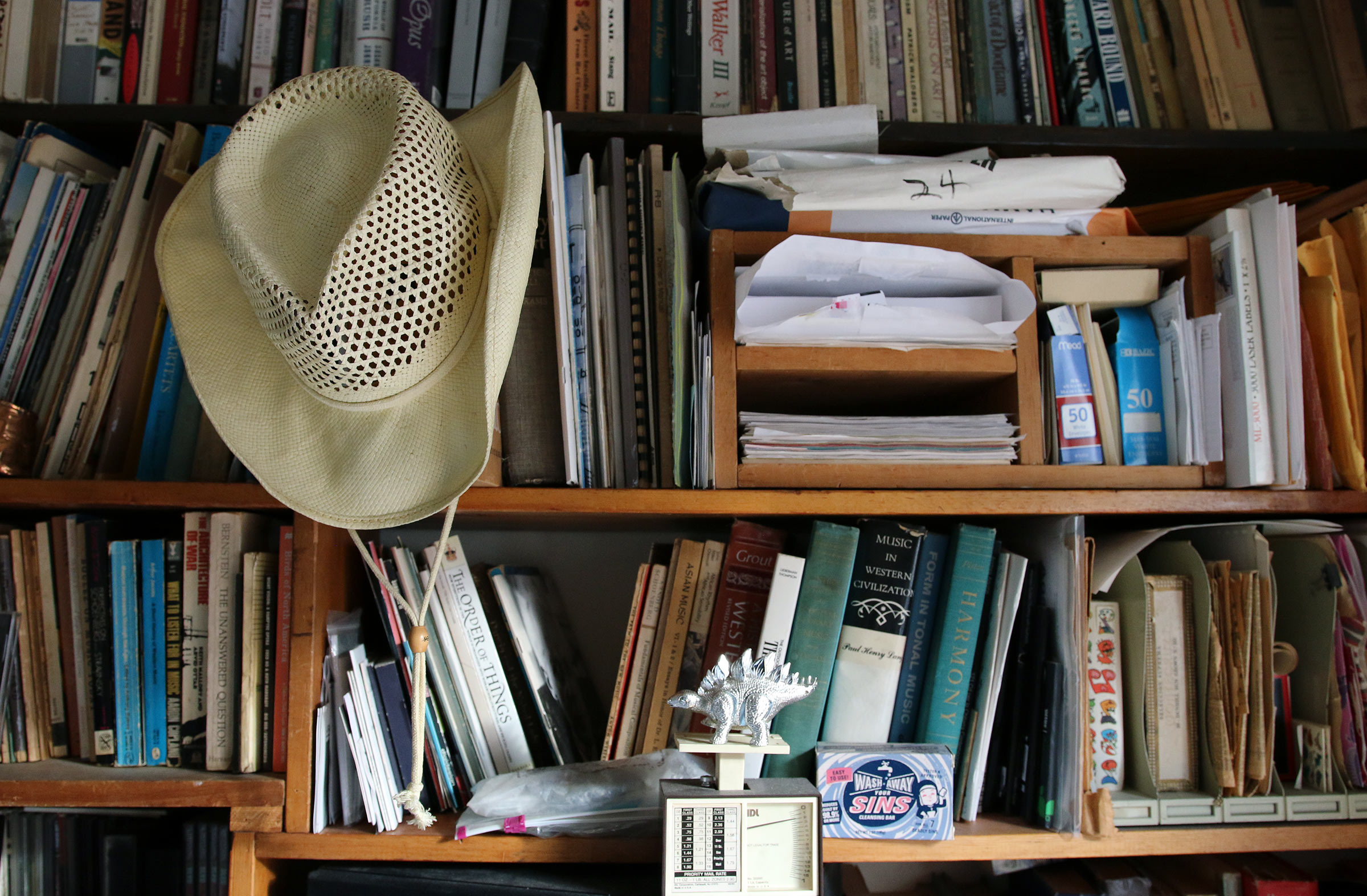One of Scott Johnson's bookcases which also contains a hat and various knick-knacks.