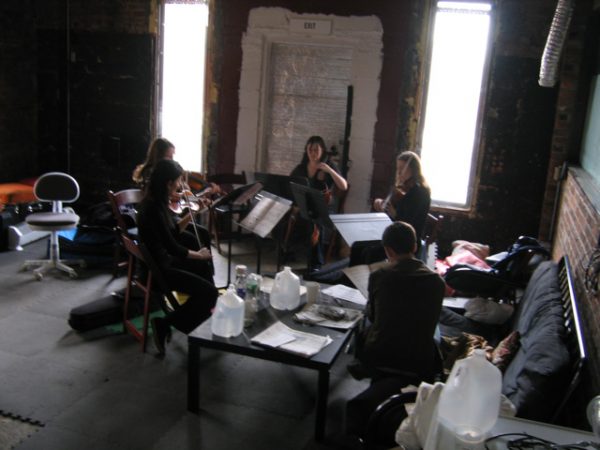  Pico Alt and Amie Weiss (violins), Miranda Silaff (viola), and Jane O’Hara (cello) rehearse Matthew Barnson's composition Sibyl Tones for a performance during the 2007 MATA Festival at the Brooklyn Lyceum.