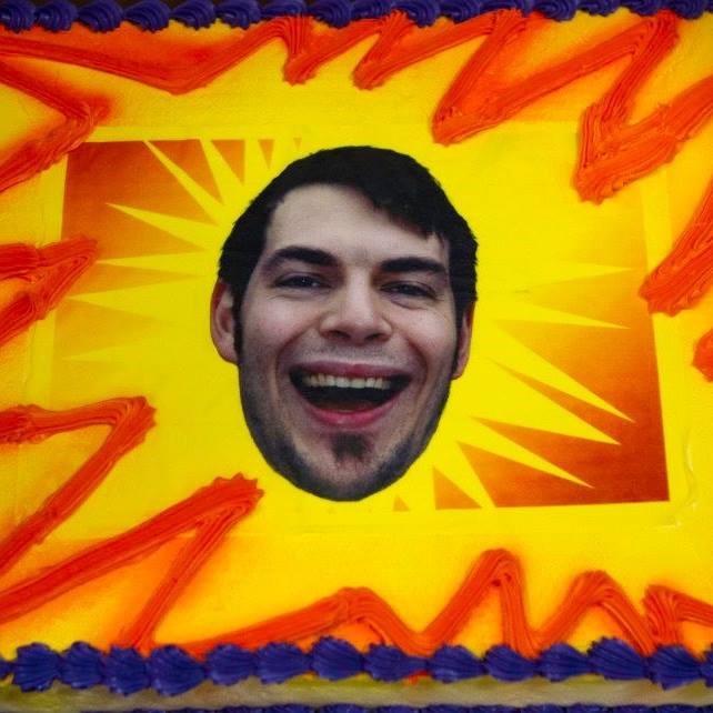 A cake with a photo of Garrett Steele's face on it.