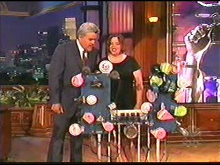 Jay Leno standing next to Wendy Mae Chambers and her Car Horn Organ
